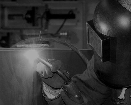 Factory worker welding steel